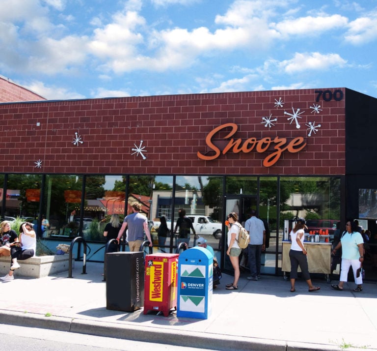 An Exterior Photo Of The Snooze Restaurant at 7th Ave & Colorado Blvd in Denver Showing The Snooze Sign