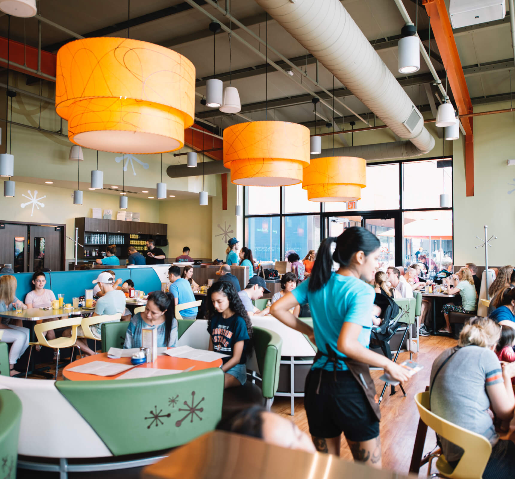 An Interior Photo Of The Snooze The Heights Restaurant Showing People Seated Eating Breakfast