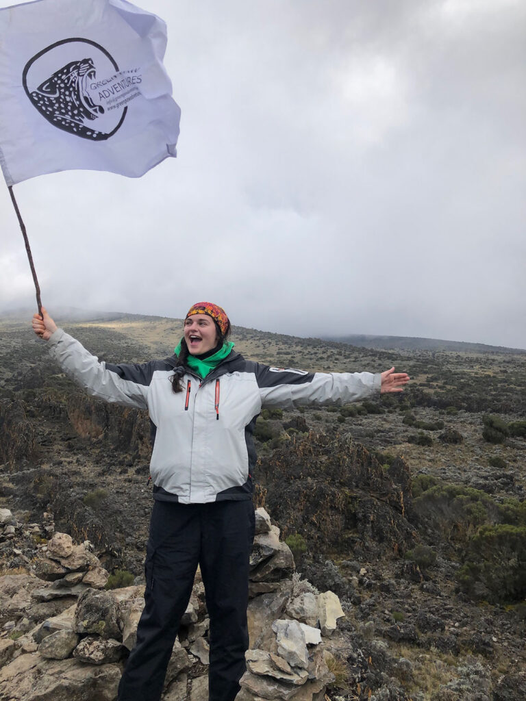 Snooze Changemaker Courtney holding flag